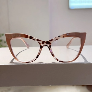 Detail of cat-eye eyewear frames with brown pink gradient and dark leopard pattern