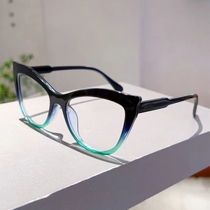 Detail of cat-eye glasses frame featuring a black to green gradient finish on display