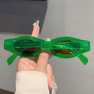 Detail view of transparent green resin sunglasses with dark brown lenses and model ZN3905
