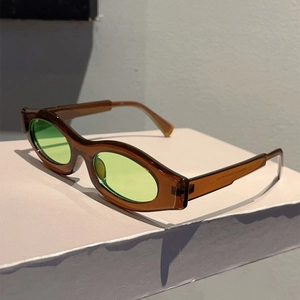 Detail view of vintage oval sunglasses with brown frames and light green lenses