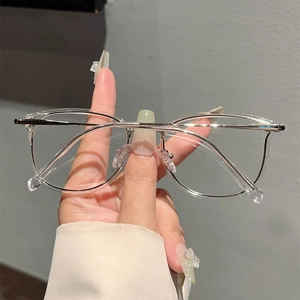 Detailed close-up of blue light blocking glasses with silver metal temples and clear frame