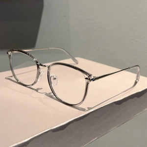 Detail of transparent grey polygonal frame with slim silver metal temples on a display