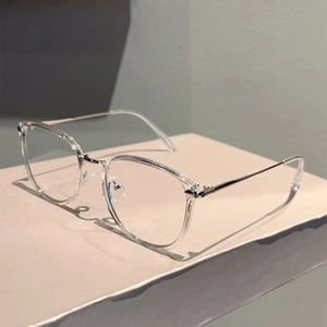 Close-up of transparent eyewear frame with slim silver metal temples on display