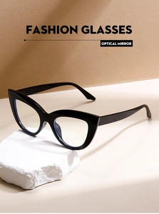Fashionable cat-eye glasses frame placed on a white stone block in a minimalist setting