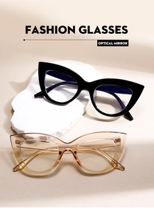 Detail view of cat eye fashion glasses with black and tea frames on white stone props