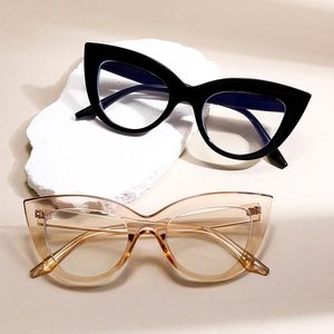 Chic cat-eye blue light blocking glasses in black and champagne frames on stone decor
