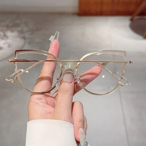 Close-up of golden cat-eye metal frame glasses with hollow double-line hollow design