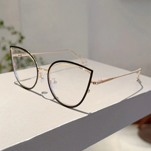 Detailed view of cat-eye frames with rose gold metal temples on a minimalist display stand