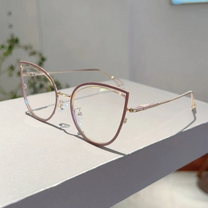 Detail of rose gold cat-eye glasses frame with light purple rims and anti-blue light lenses