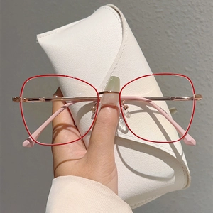 Detail of red thin metal frame glasses with rose gold temples and a white leather case