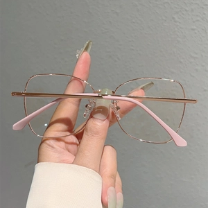 Detail of rose gold metal frame glasses with pink anti-slip tips and spring hinges