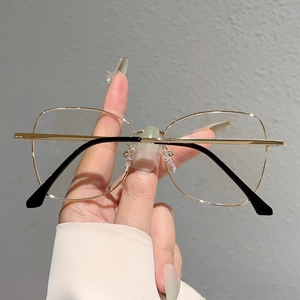 Detail of gold metal glasses frame with clear lenses and comfortable soft nose pads