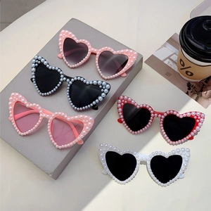 Set of heart-shaped sunglasses with pearl trim in pink, black, red, and white colors