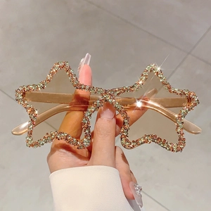 Detail of star-shaped rimless sunglasses featuring champagne rhinestones and tinted lenses