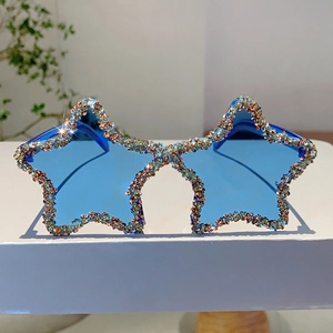 Detail of star-shaped rimless sunglasses with colorful rhinestones and blue lenses