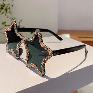 Close-up of star-shaped sunglasses featuring hand-set crystals and black lenses