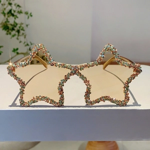 Detailed view of handmade star-shaped sunglasses with vibrant multi-colored rhinestones