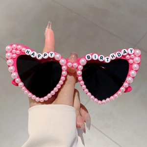 Pink heart-shaped birthday sunglasses with pearl embellishments and Happy Birthday text