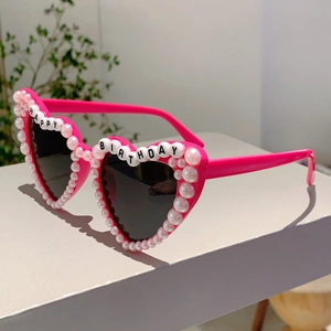 Detail of pink heart sunglasses with pearl inlay and Happy Birthday bead letters