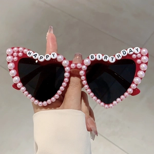 Red heart-shaped birthday sunglasses featuring pink pearls and Happy Birthday lettering