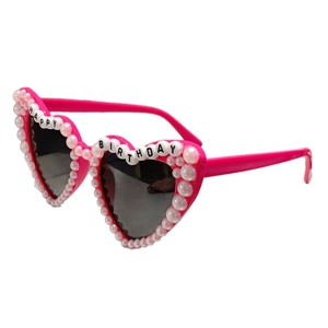 Pink heart-shaped birthday sunglasses with white pearls and Happy Birthday lettering