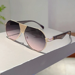 Detail of pilot sunglasses with gold metal frame and textured mesh bridge design