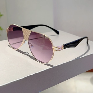Detail of gold textured bridge and purple gradient lenses on aviator sunglasses