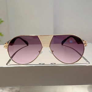 Detailed close-up of gold metal bridge with grid texture on pilot sunglasses