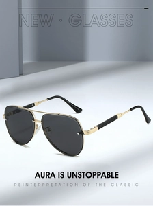 Close-up of golden aviator sunglasses with double bridge and textured metal frame detailing