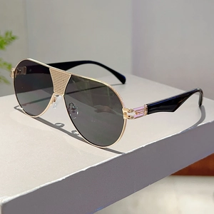 Detail of pilot sunglasses with gold metal frame and unique textured bridge grid