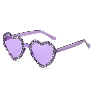 Fashionable purple heart-shaped rimless sunglasses with crystal rhinestones on white background