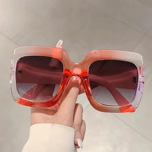 Fashionable oversized square sunglasses with orange gradient frames and tinted lenses