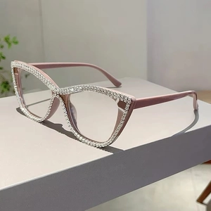 Close-up of cat-eye glasses with purple frames and hand-set sparkling rhinestones