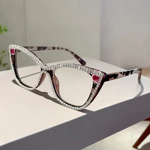 Detailed view of cat-eye eyewear frames with hand-set rhinestones and tortoiseshell texture