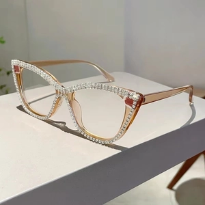 Close-up of cat eye glasses frame with champagne resin and hand-set rhinestones