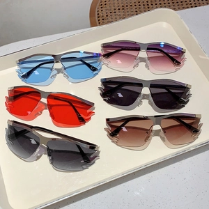 Set of six colorful flame-shaped rimless sunglasses with metal temples in a display tray