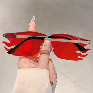 Close-up of red fire-shaped rimless sunglasses with silver metal temples and nose pads