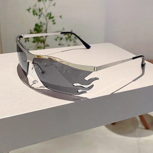 Close-up of Y2K flame-shaped grey lenses with stylish silver metal semi-rimless frames