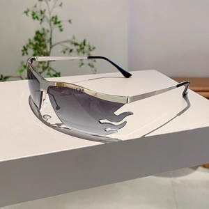 Detail of silver rimless sunglasses with grey gradient flame-shaped lens design