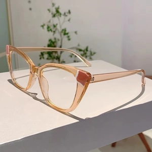Detail view of cat eye glasses with transparent amber frame and geometric accent