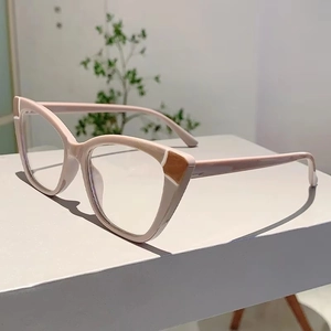 Detail of nude pink cat-eye glasses frame with brown patchwork design on a clean stand