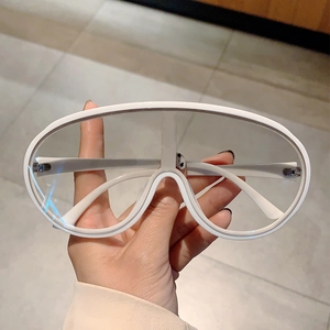 Detail view of stylish white Y2K oversized sunglasses with clear lenses and thick frames