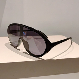 Detail of trendy black oversized Y2K shield sunglasses with seamless purple lenses