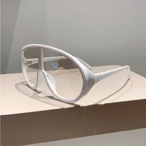 Close-up of trendy white oversized Y2K sunglasses with thick frame and clear lenses