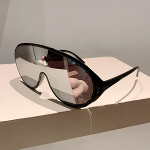 Detail of silver mirrored lens on oversized Y2K wrap around sports sunglasses