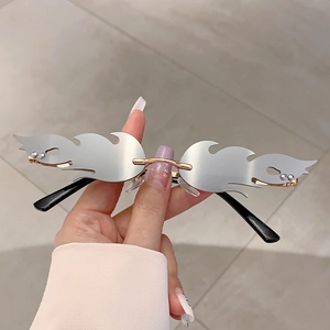 Detail of silver mirror flame-shaped rimless sunglasses with rhinestones and gold bridge