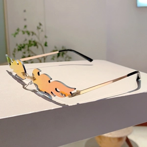 Detail of flame-shaped rimless sunglasses featuring orange gradient lenses and diamond accents