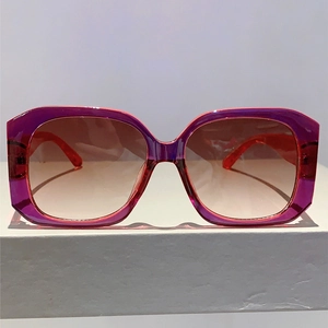 Detail of square oversized sunglasses with purple translucent frames and gradient lenses