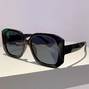 Detail view of bold square black frame sunglasses with dark lenses at 45-degree angle