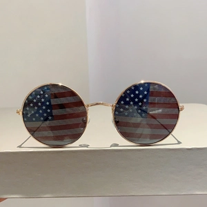 Detailed macro of gold metal frame sunglasses with American flag pattern lenses